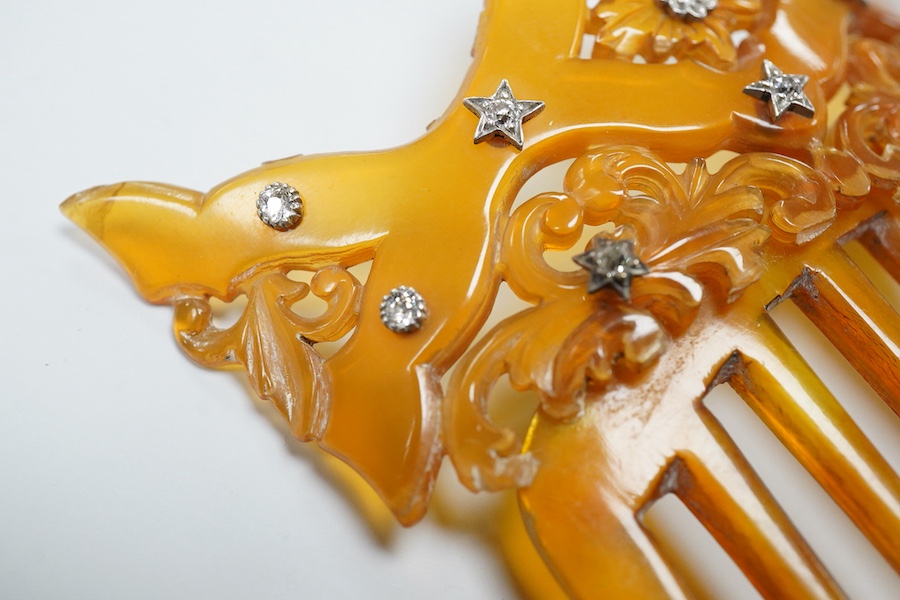 An early 20th century tortoiseshell hair comb set with eleven diamonds, 99mm by 83mm.